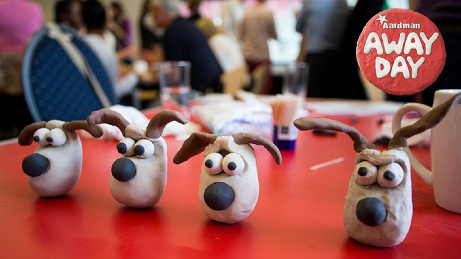 Four clay models of Aardman's Gromit with an 'Aardman Away Day' logo in the top corner